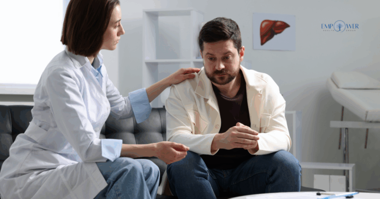Man sitting with therapist offering support, symbolizing depression and addiction treatment at Empower Health Group