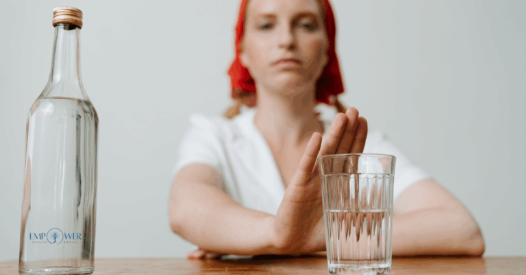 Person rejecting a drink, representing commitment to sober living services at Empower Health Group